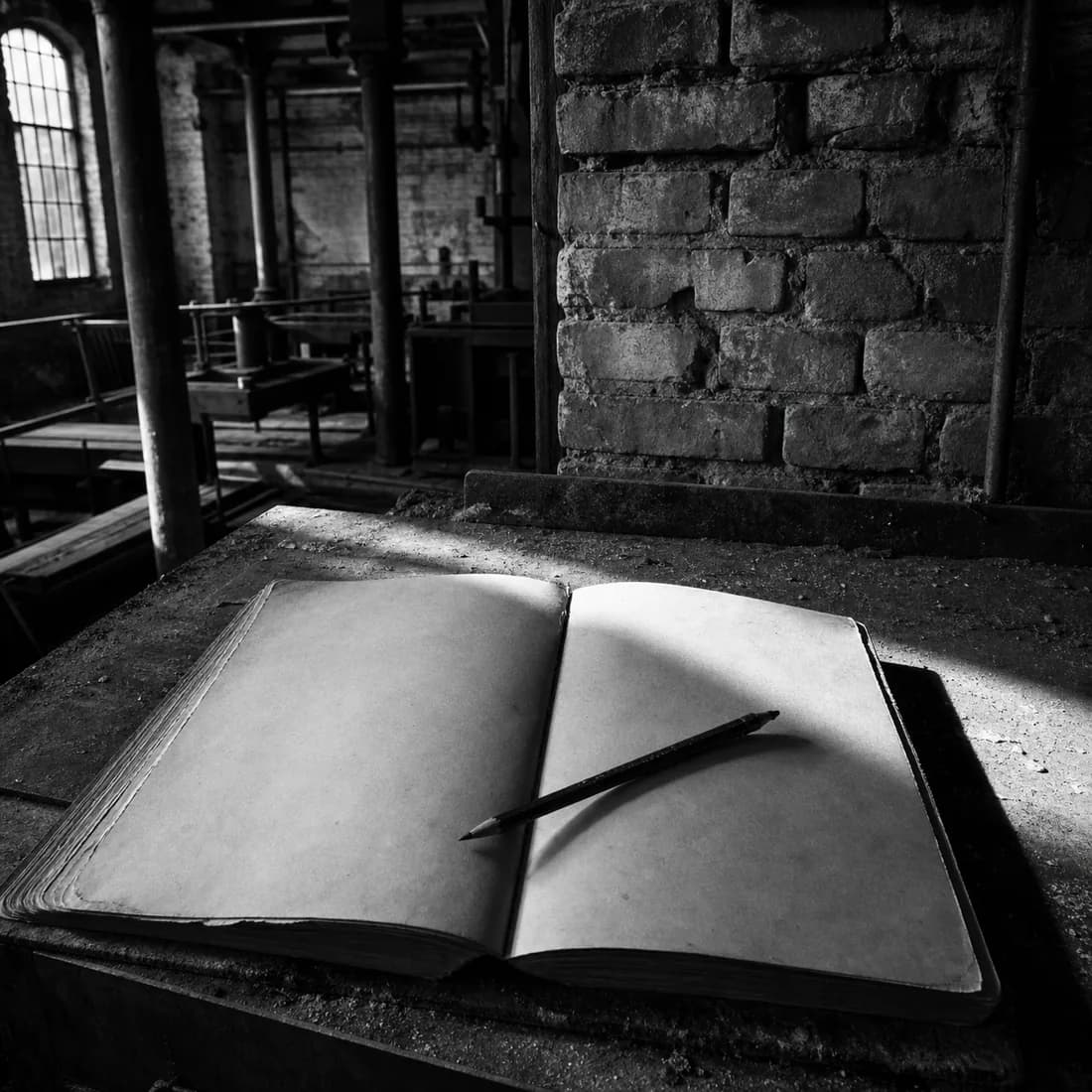 A worn logbook open on a chalk-dusted bench with a pencil across it, hard window light, mill brick behind