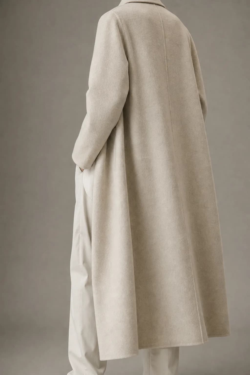 Back view of the agnes coat, an ecru double-faced recycled-wool overcoat worn open
