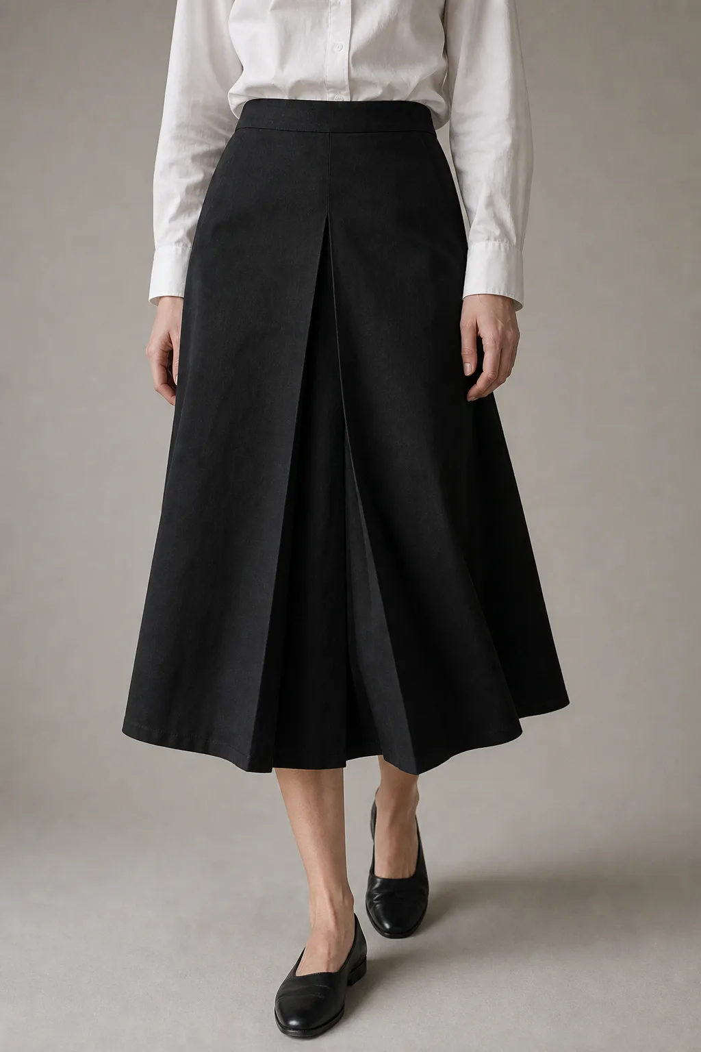 Ink cotton-twill lena skirt with a deep single pleat, cropped ribcage to mid-calf